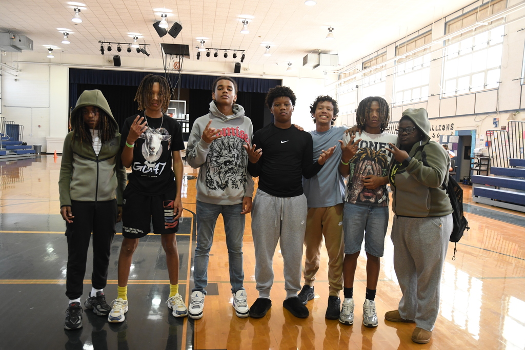 students posing in a group photo in the gym