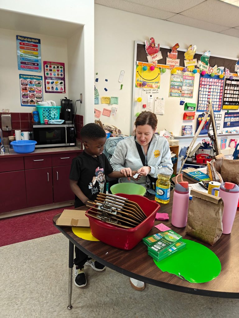 A teacher helping her student prepare to make popcorn. 