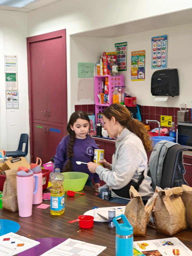 A teacher helping her student prepare to make popcorn. 