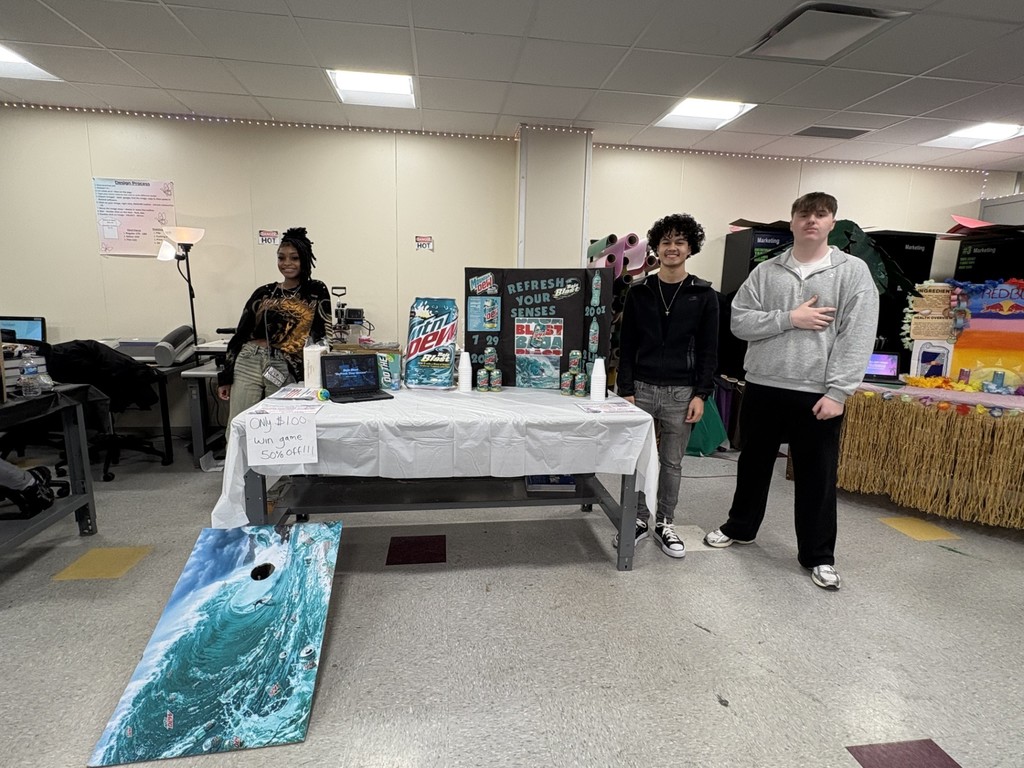 Students hosting a cornhole game for Mtn. Dew. 