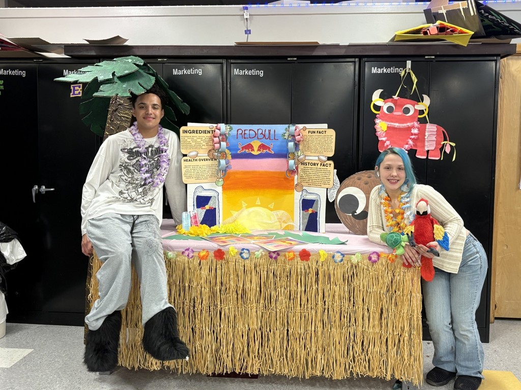 Students hosting a table for Redbull. . 