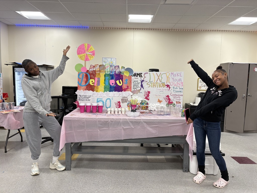 Students hosting a colorful table with delicious drinks. 