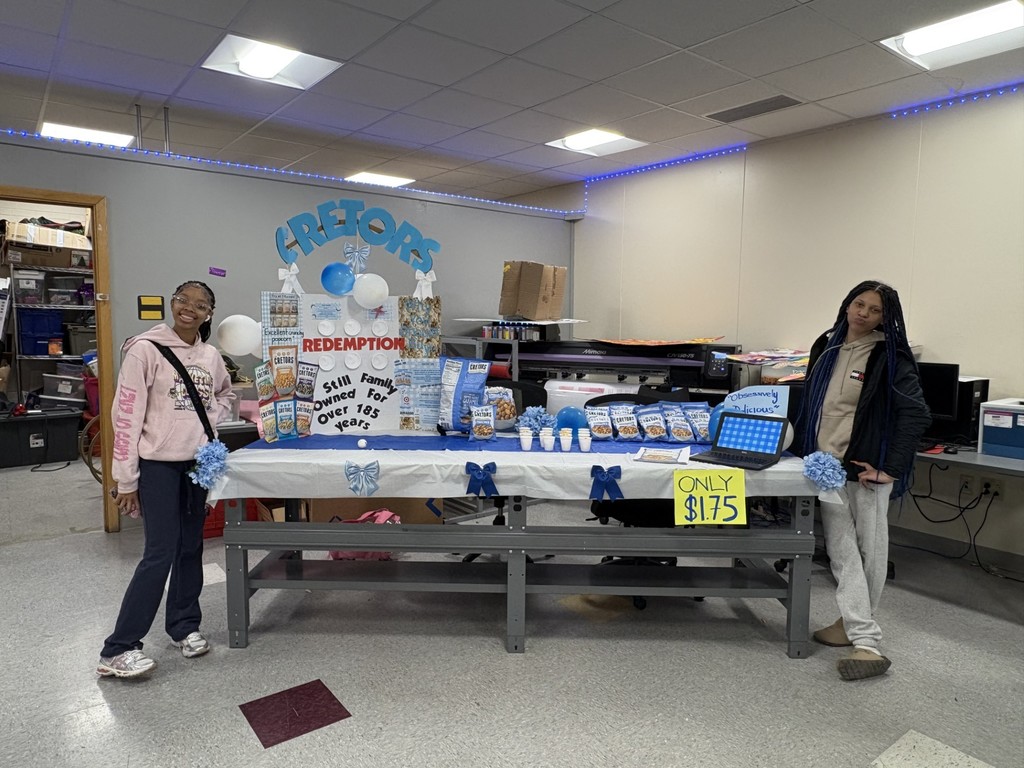 Students hosting a table a fun game. 