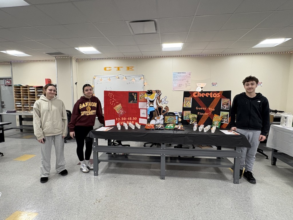 Students hosting a table for different Cheetos. 