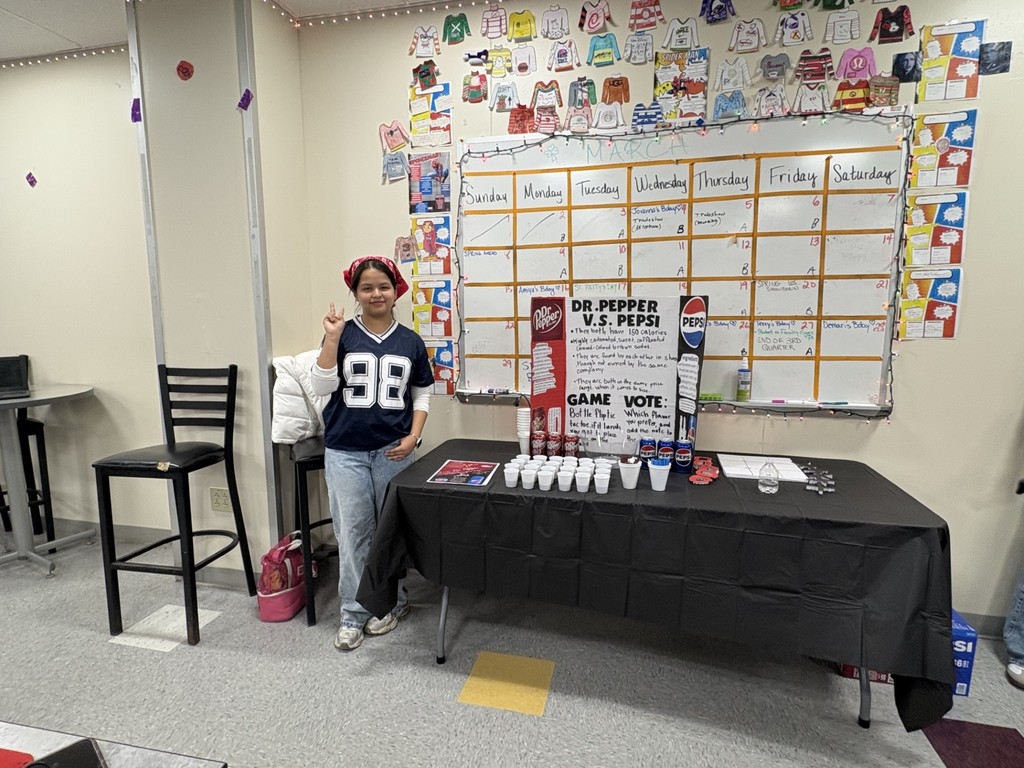 Students hosting a table for Dr. Pepper versus Pepsi  to see which one people prefer. 