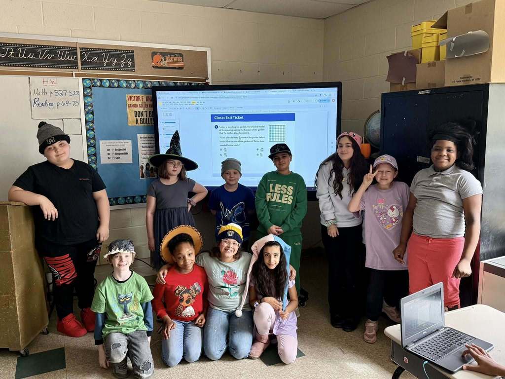 Students wearing different kinds of fun hats in a classroom. 