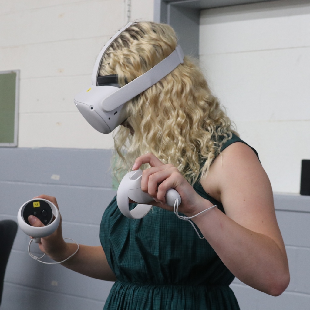 TMS student using VR glasses to solve math problems.