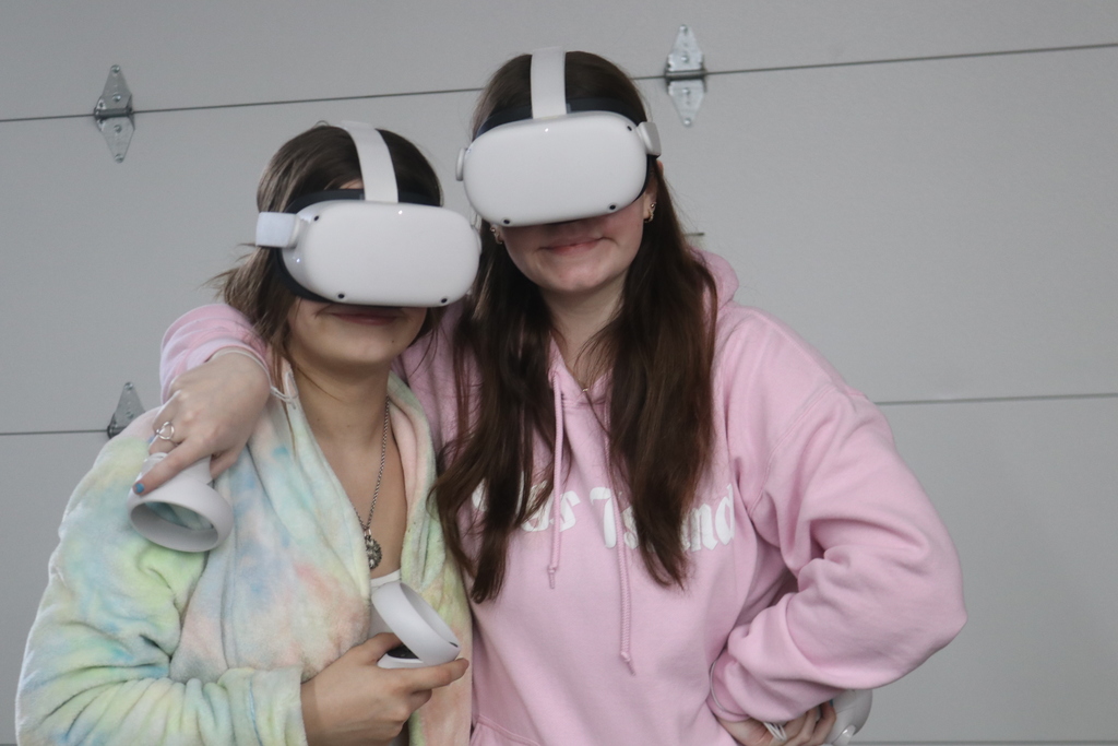 Two TMS girls pose with the VR glasses on before solving problems.