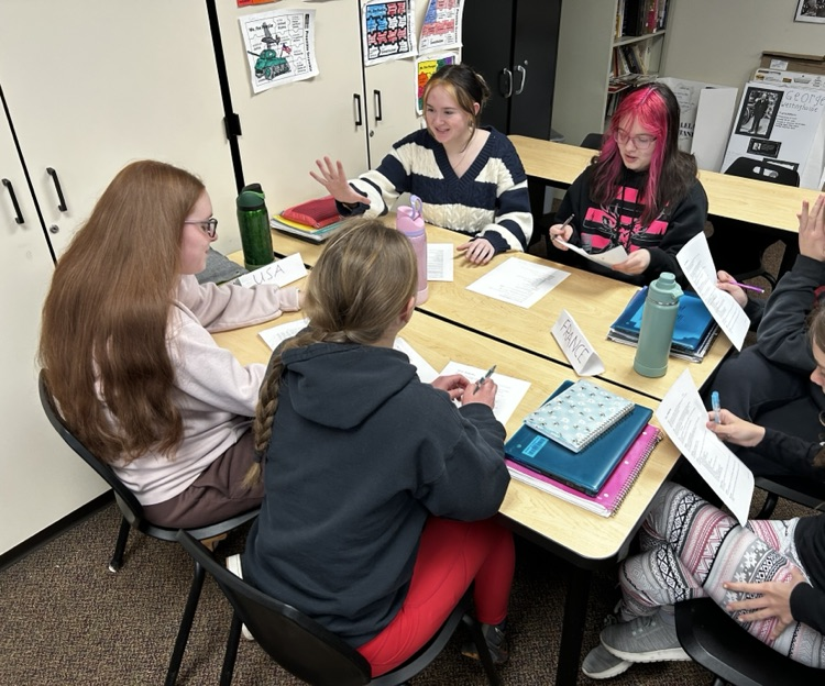 students sitting in groups, talking together