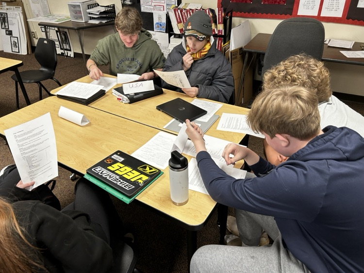 students sitting in groups, talking together