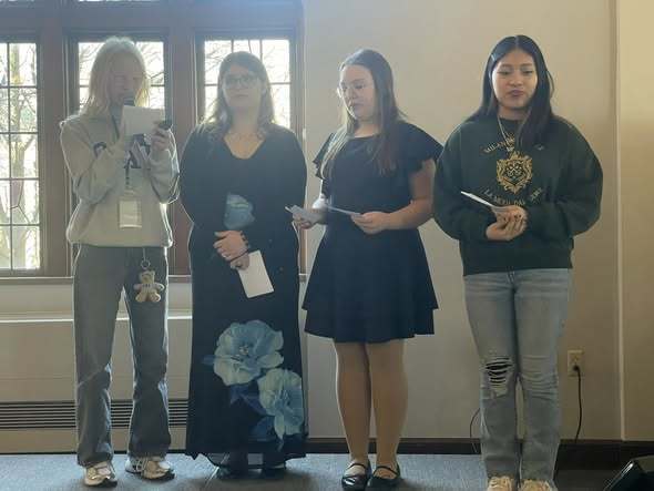 Students presenting their project on stage. 