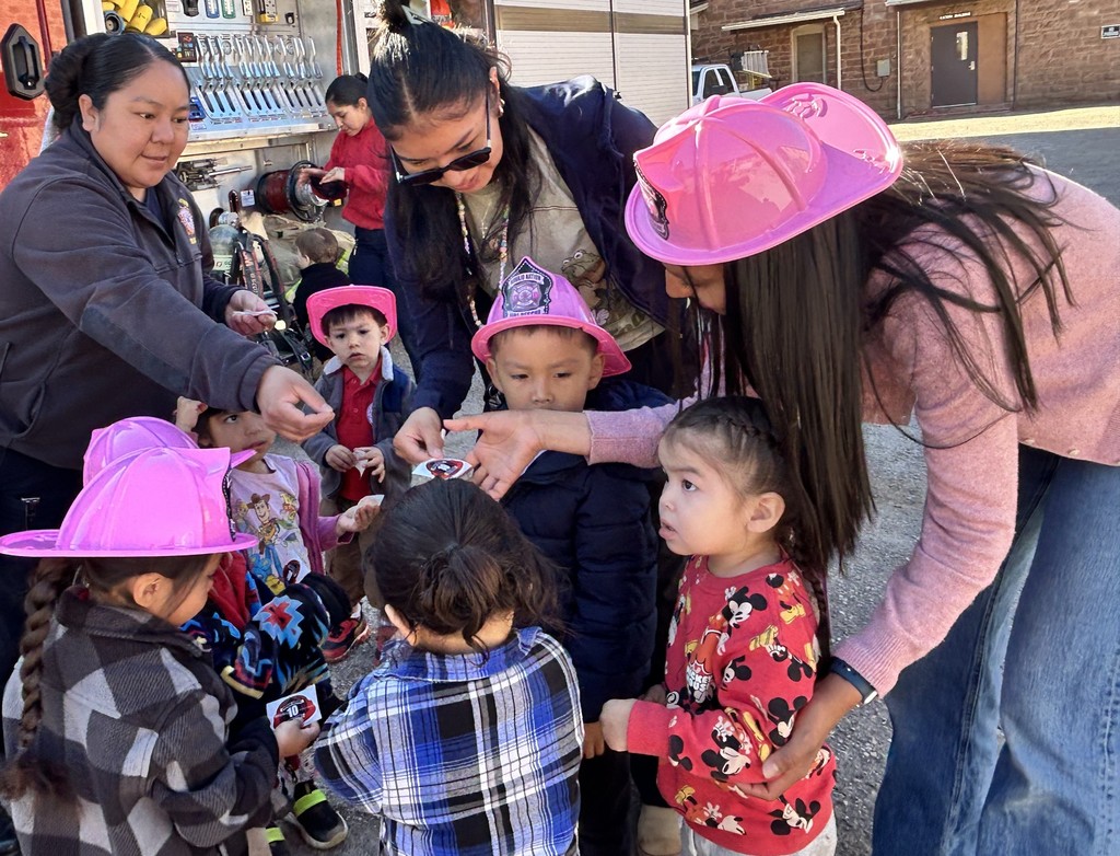 PreK getting stickers from fire fighter