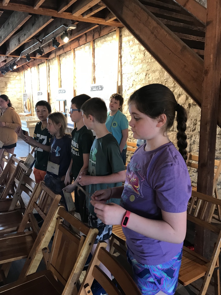 Students standing in a line listening to a presentation