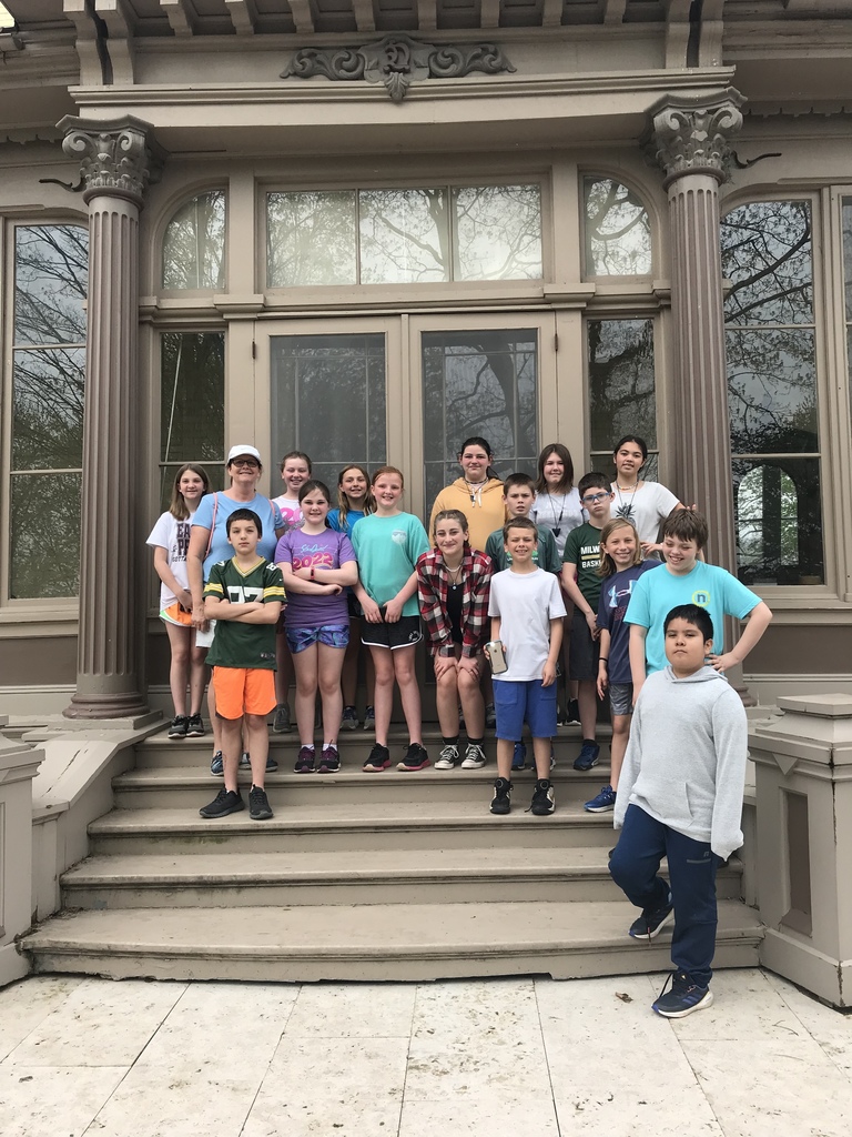 Students posing for a picture outside an old building at Villa Louis
