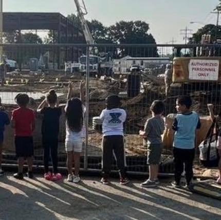 Students looking at the construction of the new Edison Building. 