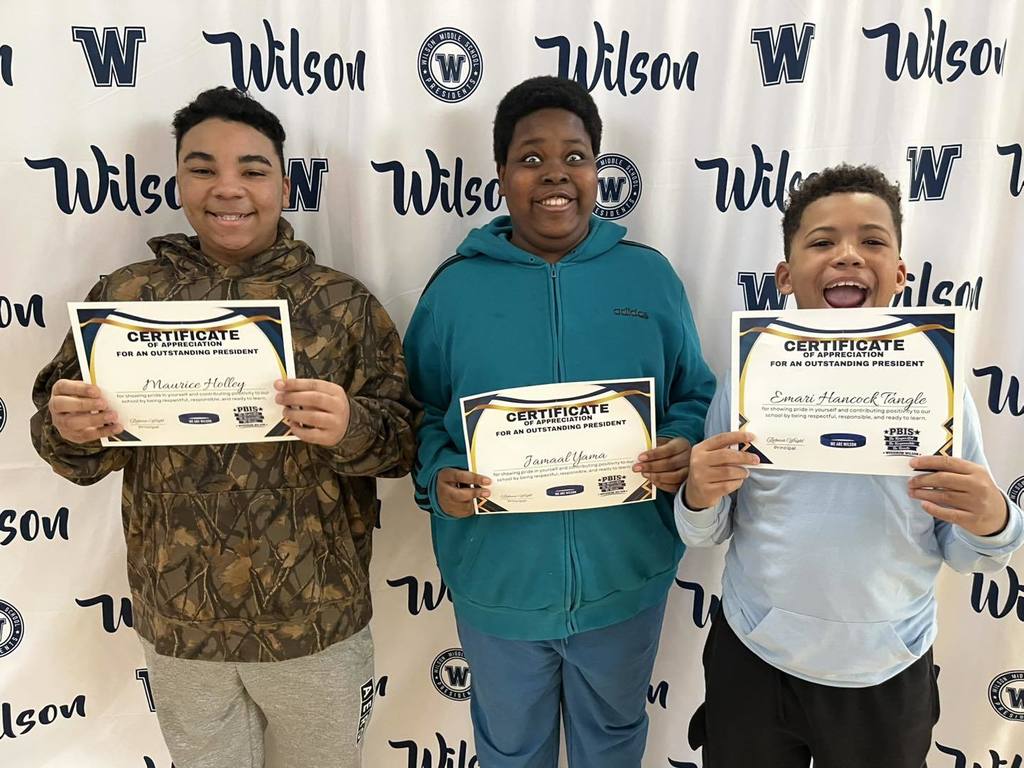 Students holding their certificates. 