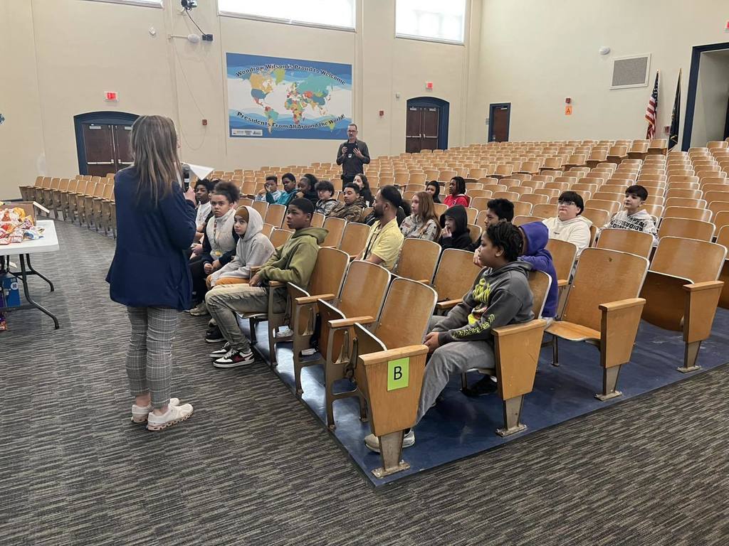 A women talking to students who are sitting in the auditorium. 
