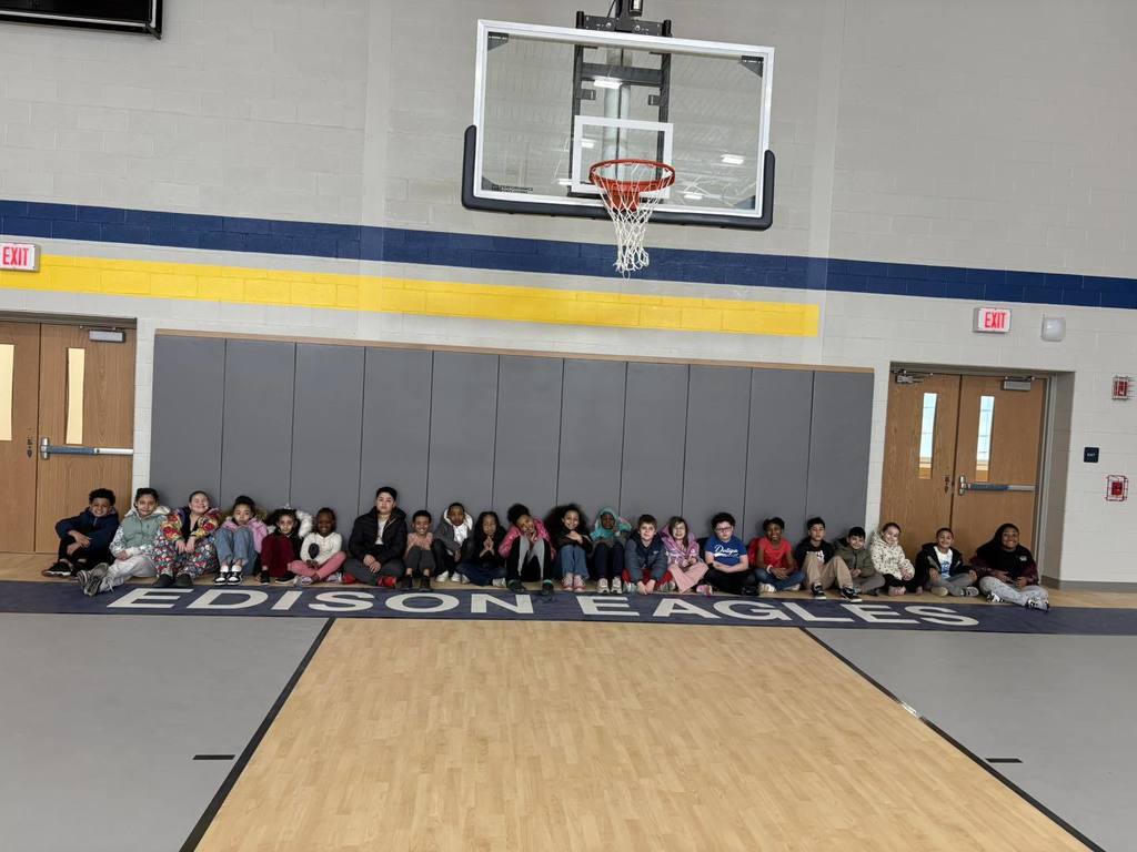 Students sitting on the floor of the new Edison Elementary gym. 