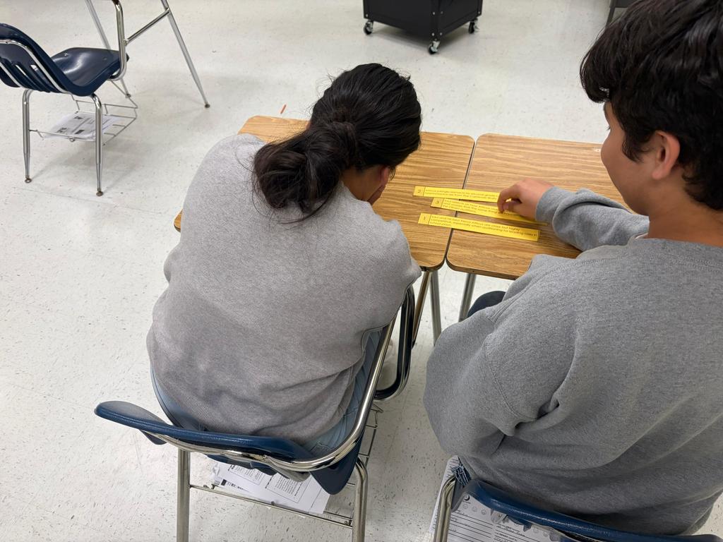 A pair of students tries to answer a STAAR review question for English