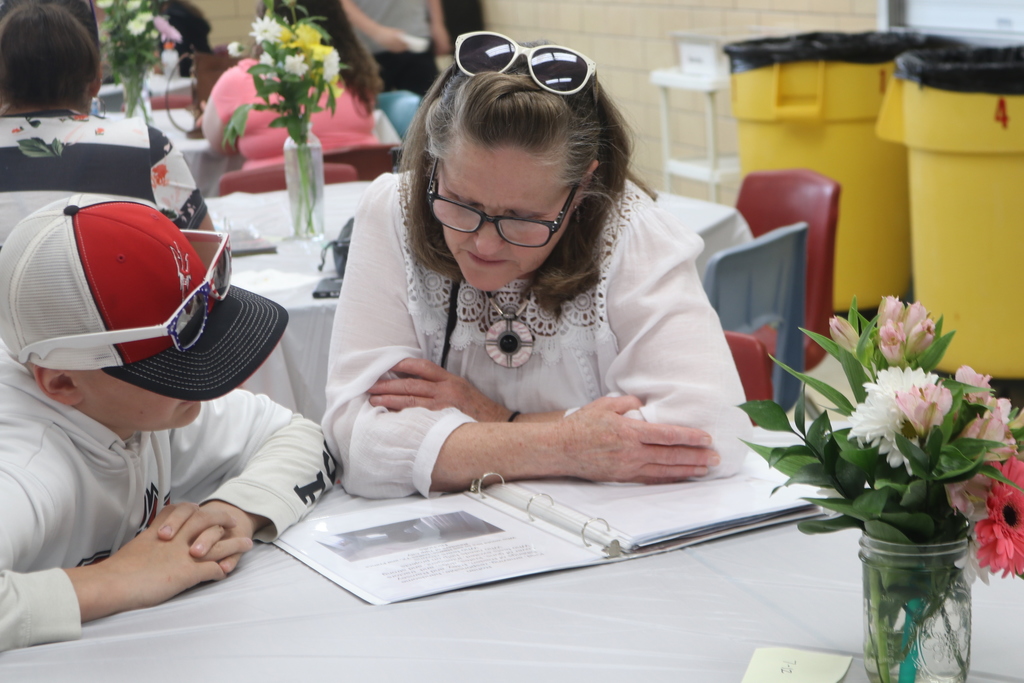 A child reads his poem to his mom.