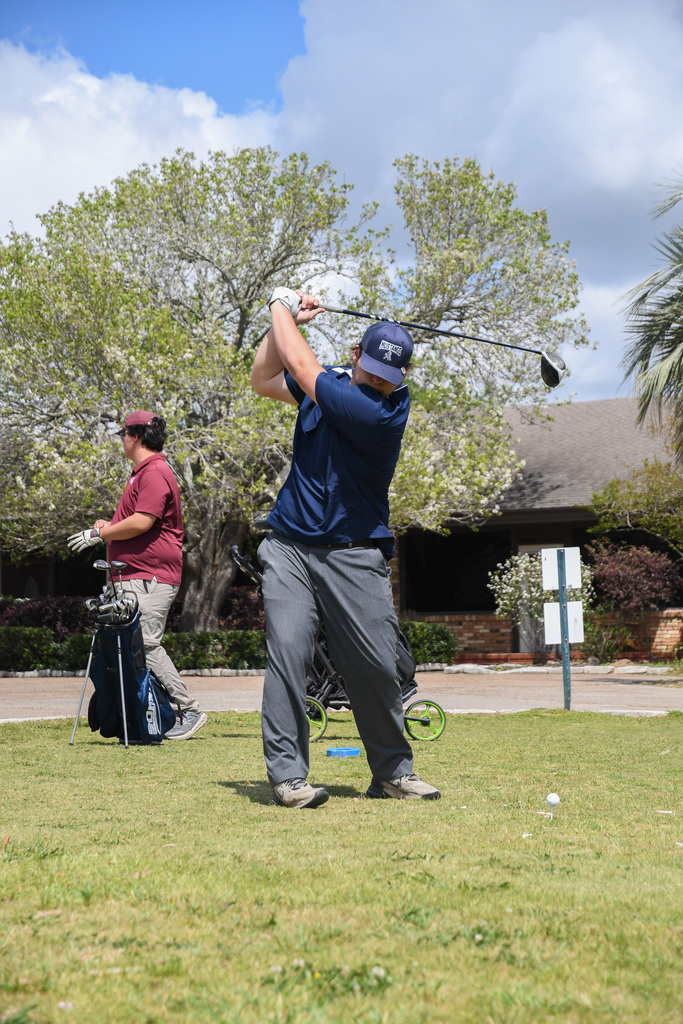 William Pugh preparing to hit a golf ball