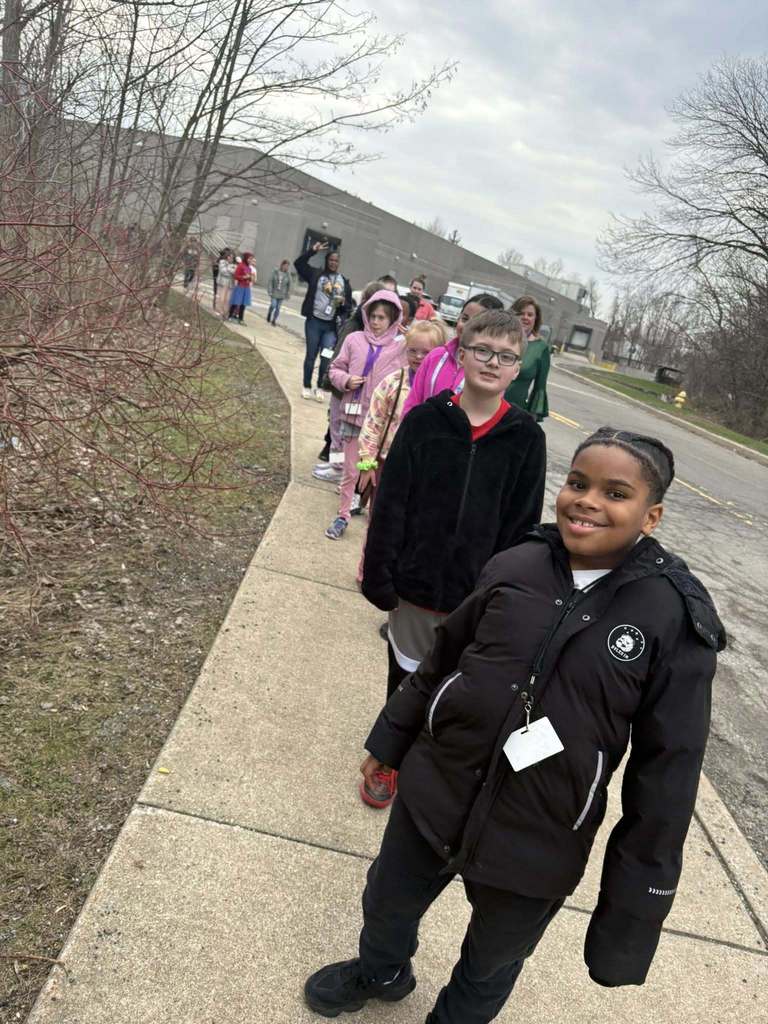 Students walking on a sidewalk. 