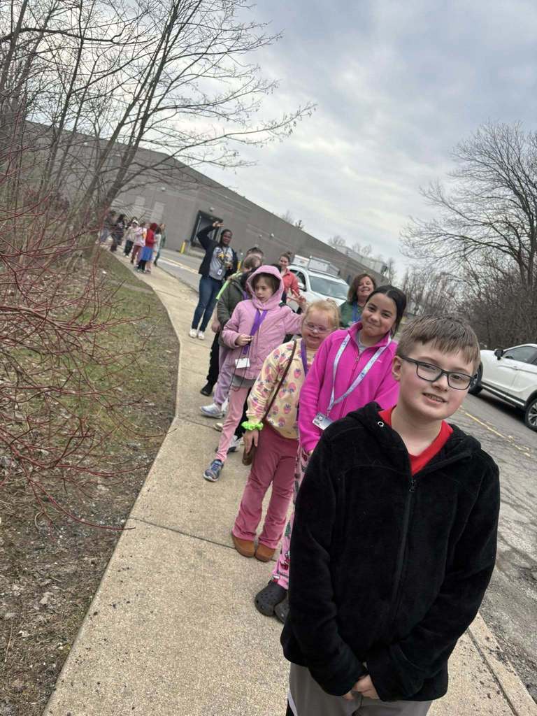 Students walking on a sidewalk. 