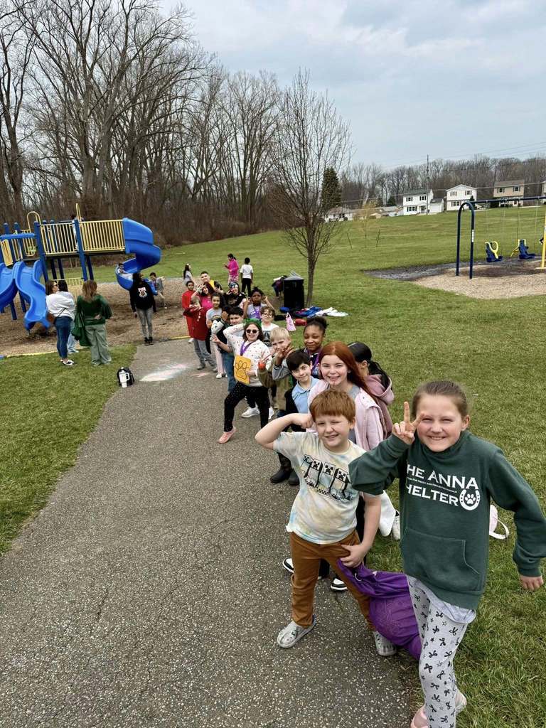 Students posing at a playground. 