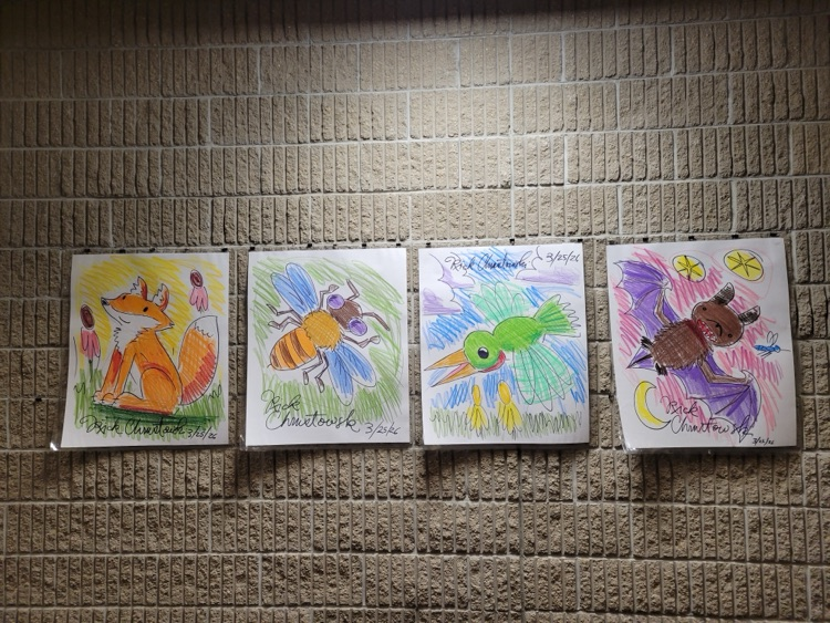 Rick’s illustrations hanging in hallway