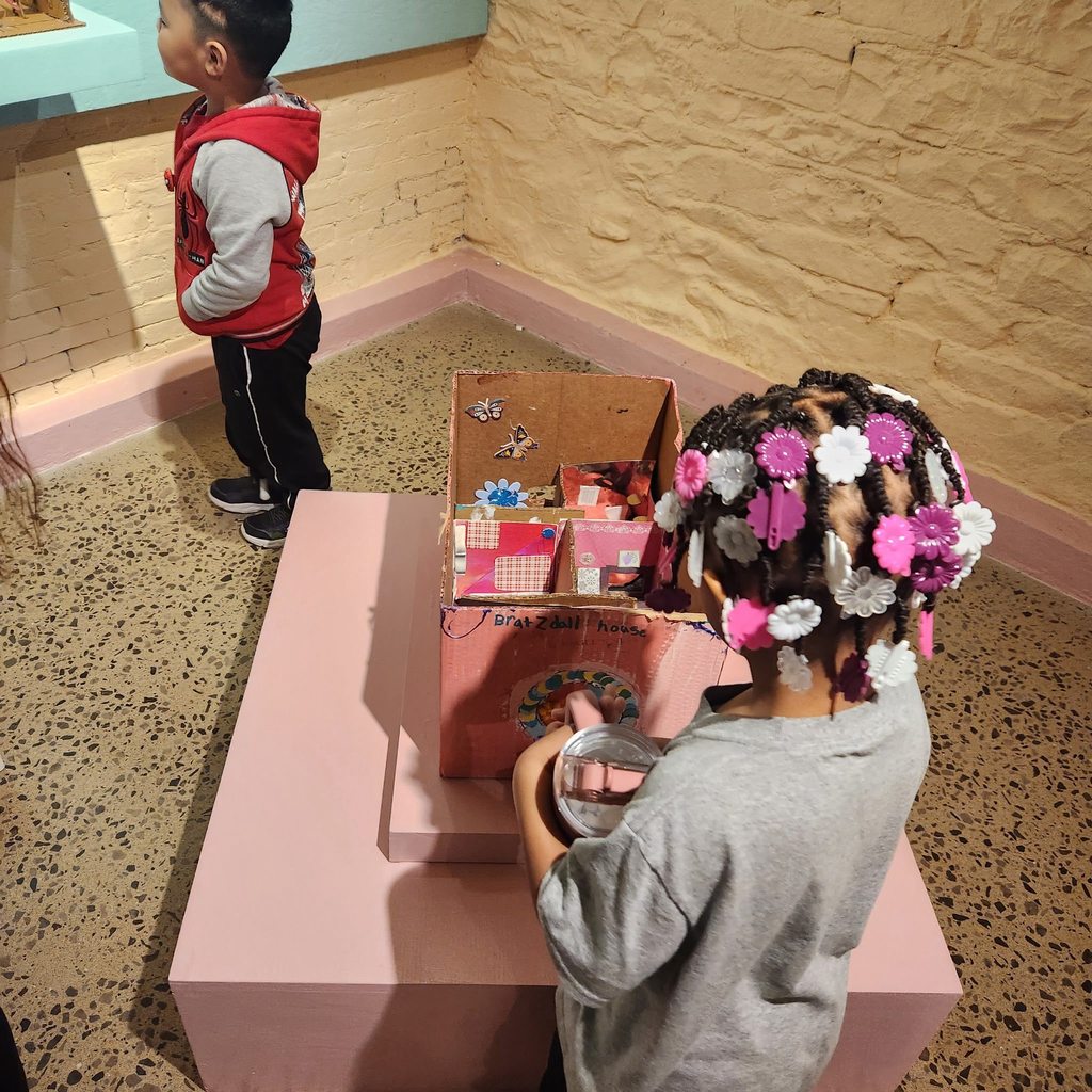 Kids playing with dollhouses. 