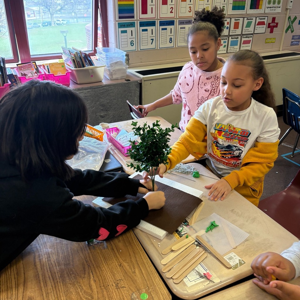 Students making windbreaks to protect plants from hazardous weather.