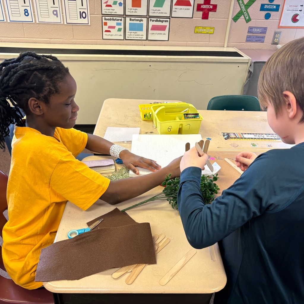 Students making windbreaks to protect plants from hazardous weather.