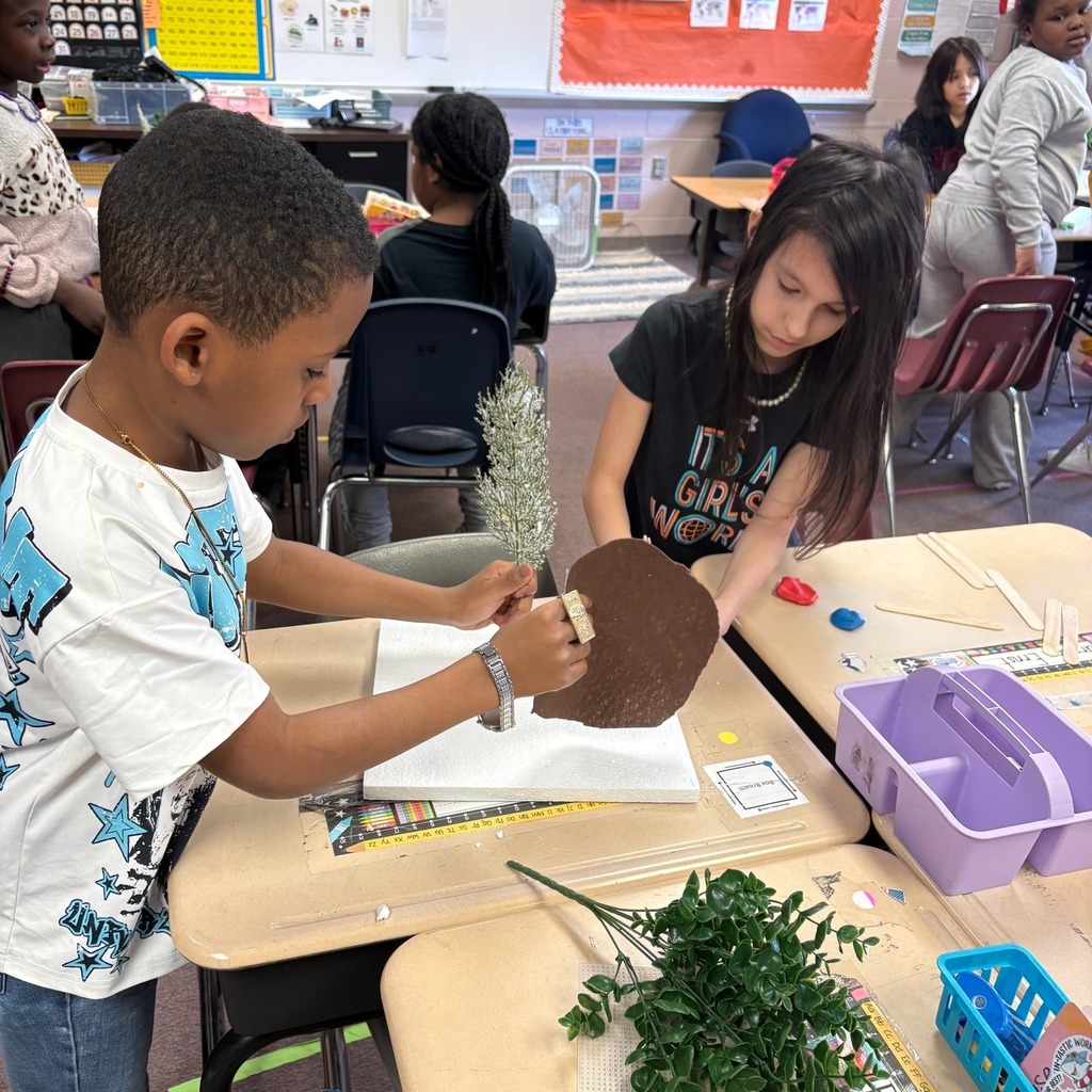Students making windbreaks to protect plants from hazardous weather.