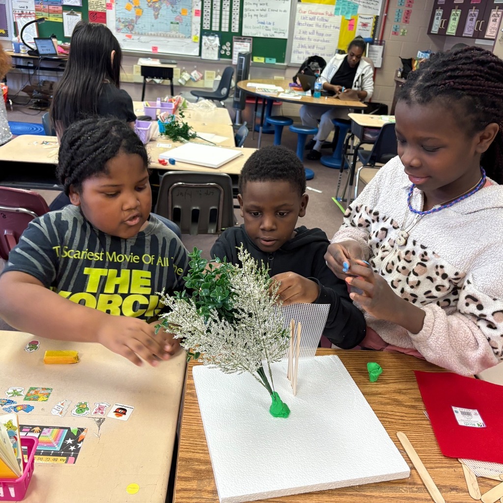 Students making windbreaks to protect plants from hazardous weather.