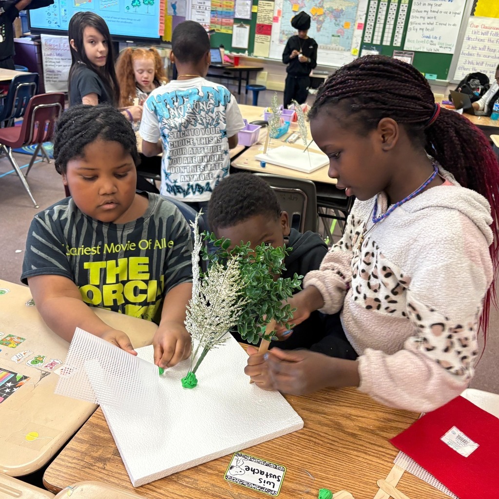 Students making windbreaks to protect plants from hazardous weather.