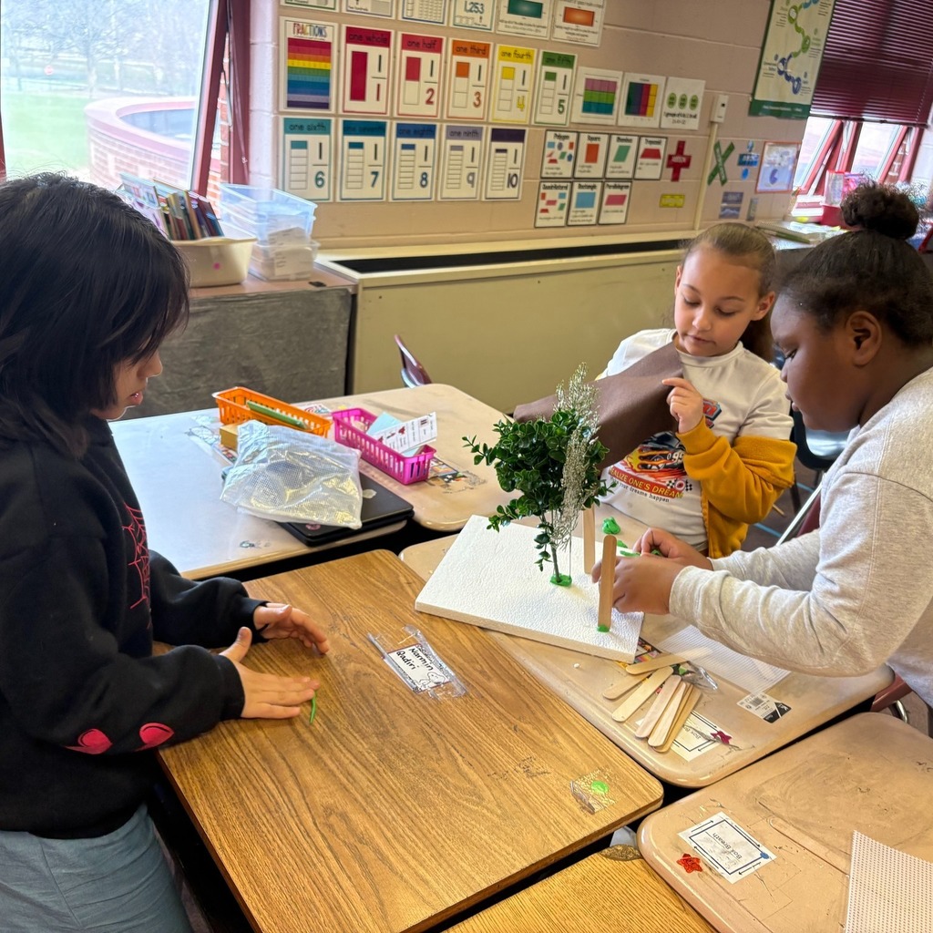 Students making windbreaks to protect plants from hazardous weather.