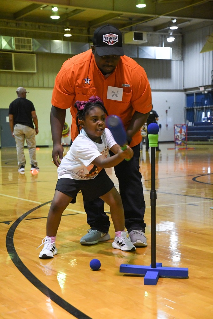 man and daughter playing baseball activities