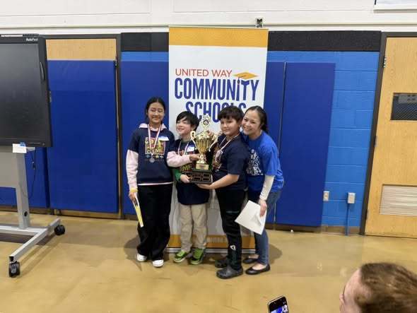 A mom standing next to three students who are the three finalists in the challenge 24 contest. 