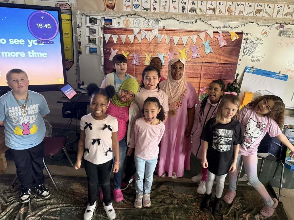 Students posing for a photo in their classroom.