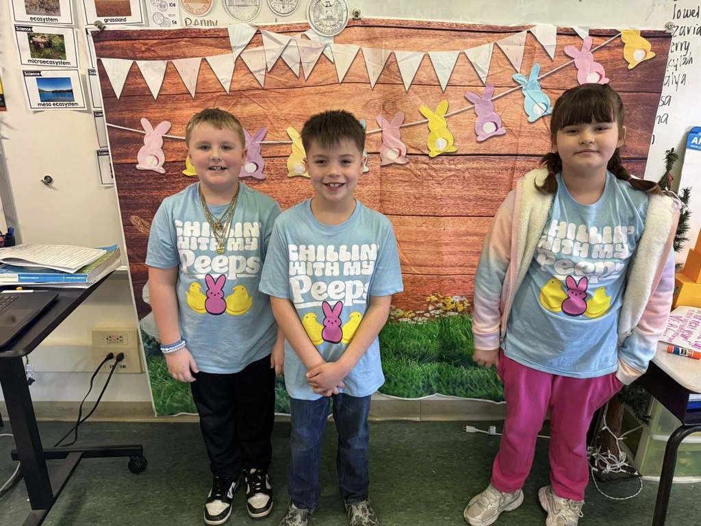 Three students wearing matching shirts that say " chillin' with my peeps" and they are posing for a photo.