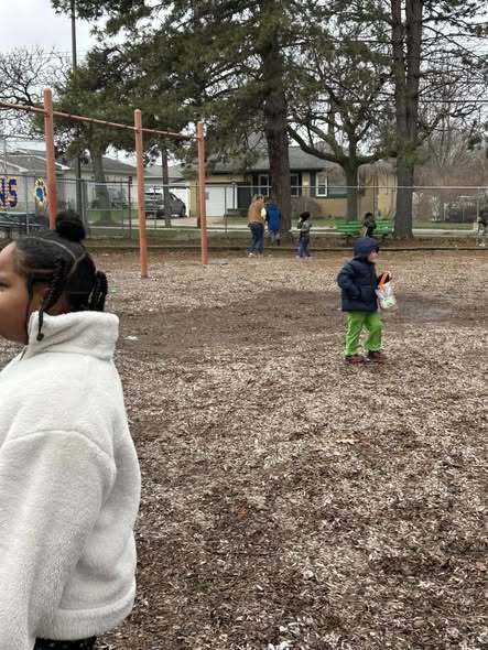 Students looking for easter eggs outside. 