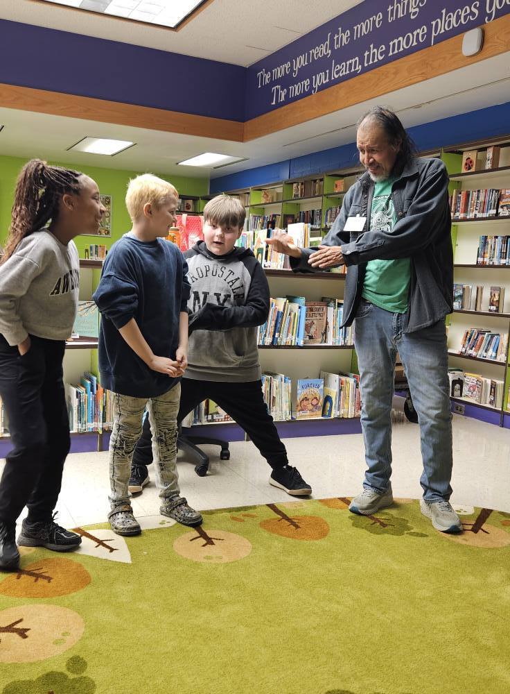 Robert Lewis is talking to students. 