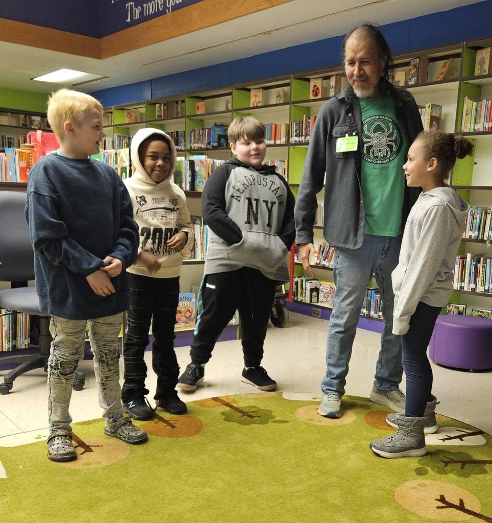 Robert Lewis is talking to students. 