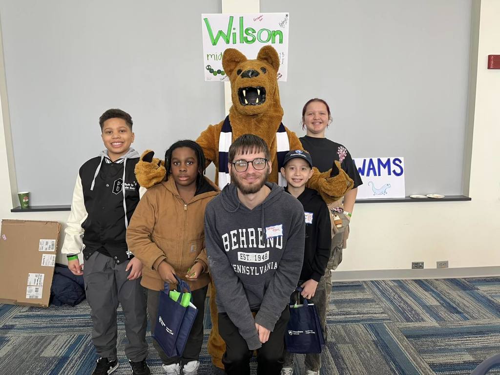 Students posing with the Penn State Mascot. 