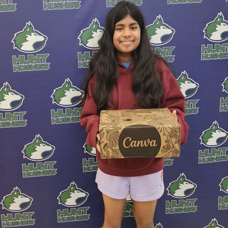 student holding Canva box