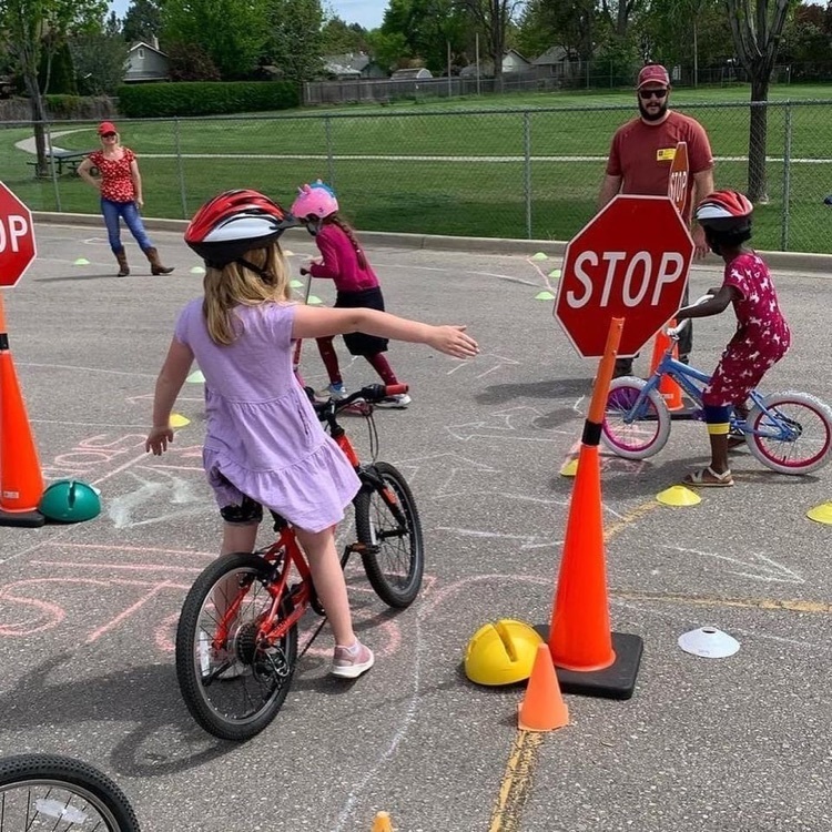 student riding bike does right hand signal