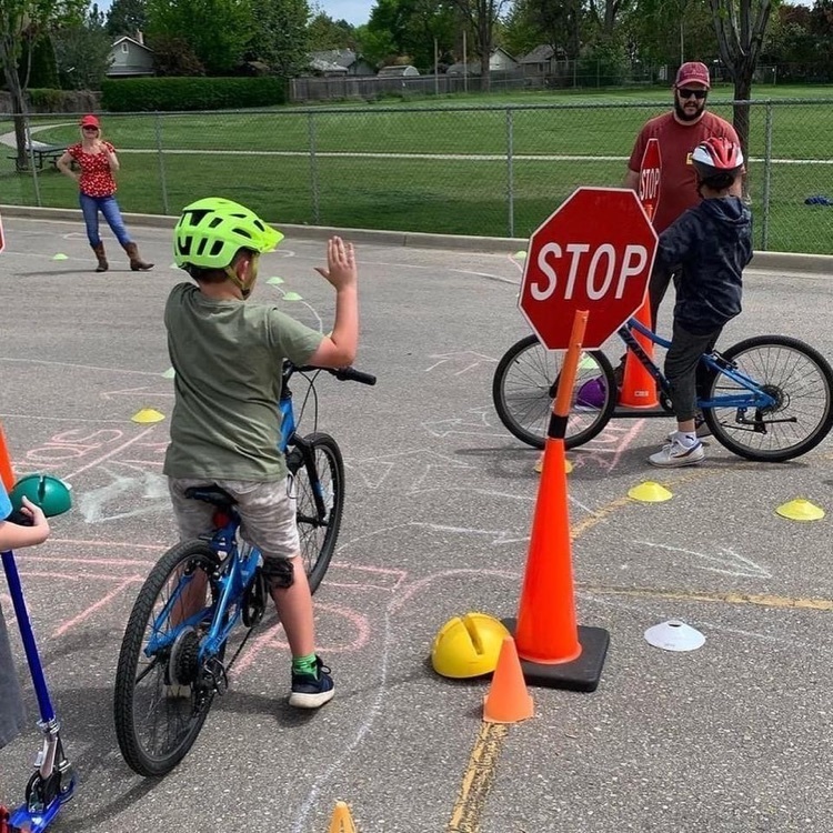 student riding bike does left hand signal