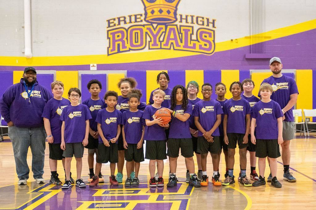 The Perry Elementary Basketball team posing for a photo with Perry staff. 
