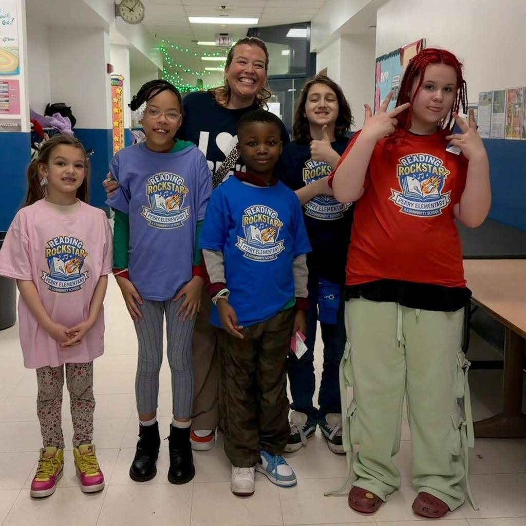 Students are posing with the Assistant Principal at Perry Elementary School. 