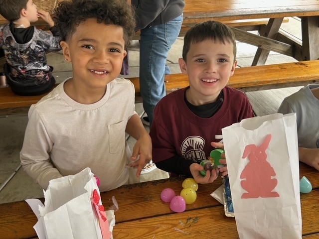 Two boys counting eggs with easter bags